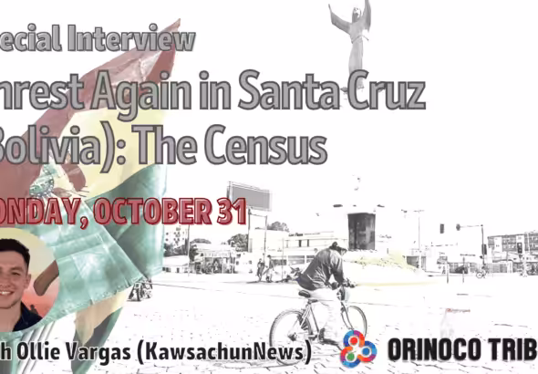 Poster with details of the interview and a watermarked photo the Bolivian flag near a roundabout in Santa Cruz, Bolivia. Photo: Orinoco Tribune.