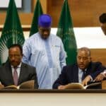 Representative of Ethiopian government, Redwan Hussien, (seated left) and representative of TPLF, Getachew Reda, (seated left) signing the agreement in Pretoria, South Africa, on November 2, 2022. Photo: Phill Magakoe/AFP.