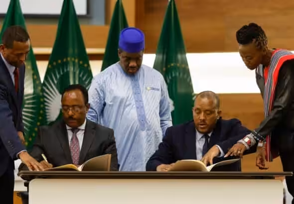 Representative of Ethiopian government, Redwan Hussien, (seated left) and representative of TPLF, Getachew Reda, (seated left) signing the agreement in Pretoria, South Africa, on November 2, 2022. Photo: Phill Magakoe/AFP.