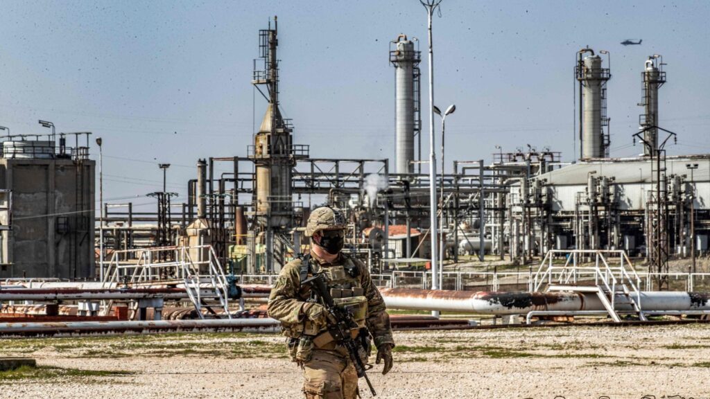 A US soldier with a refinery in the background. Photo: AFP.