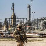 A US soldier with a refinery in the background. Photo: AFP.