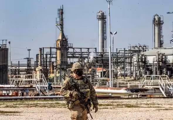 A US soldier with a refinery in the background. Photo: AFP.