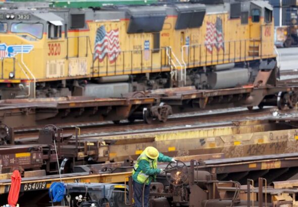 A rail employee works a Union Pacific Intermodal Terminal rail yard on November 21, 2022 in Los Angeles, California. Photo: Mario Tama/Getty Images.