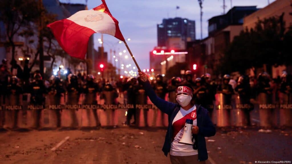 Peruvian protester stands in defiance of the police. Photo: Alessandro Cinque.