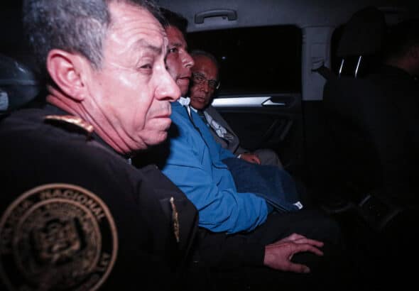 Peruvian President Pedro Castillo being transferred to the Lima Prefecture, a few minutes after his controversial detention. Photo: AFP/Renato Pajuelo.