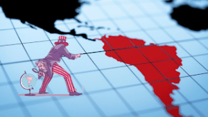 Map of the Western Hemisphere with South America colored in red, an “Uncle Sam” can be seen in a corner pointing at it. Photo: Prensa Latina.