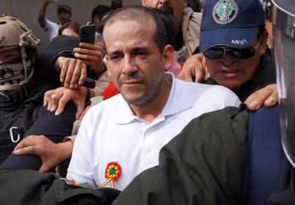 The governor of Santa Cruz, Luis Fernando Camacho, being escorted by the Bolivian police after his arrest in the Coup d'État I case. Photo: Javier Mamani/Getty Images.