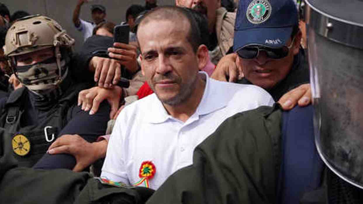 The governor of Santa Cruz, Luis Fernando Camacho, being escorted by the Bolivian police after his arrest in the Coup d'État I case. Photo: Javier Mamani/Getty Images.