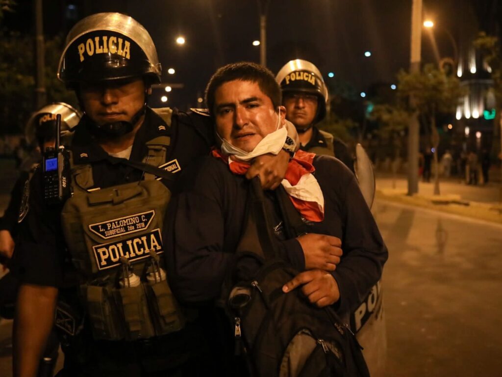 Police detain an activist calling for the return of deposed president Pedro Castillo. Photo: Juan Zapata.