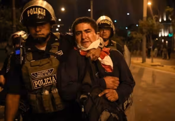 Police detain an activist calling for the return of deposed president Pedro Castillo. Photo: Juan Zapata.