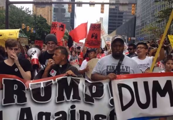Father José Landaverde leading chants on the march on the Republican National Convention in Cleveland, Ohio. Photo: FightBack News