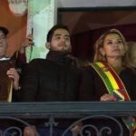 Jeanine Añez, after proclaiming herself de facto president of Bolivia, with a bible in her hand. Luis Fernando Camacho is next to her (left) holding a bigger bible. Photo: PA Images.