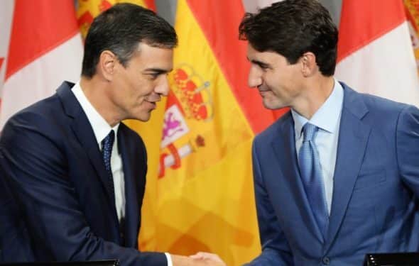 Vassal meeting fellow vassal: Pedro Sanchez, Spain's PM, shakes hands with Canada's Justin Trudeau. Their nations are no longer sovereign, but submission to the US-enforced "Rules-Based Order" does not seem to bother them. File photo.