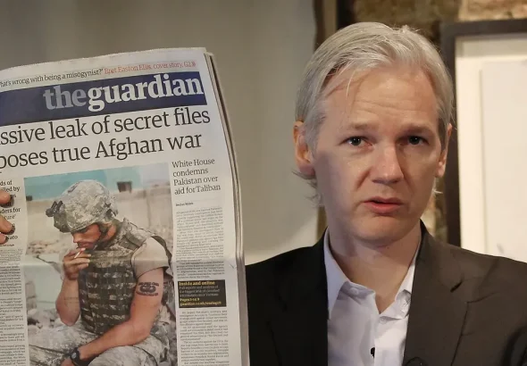 Julian Assange holding in his hands the newspaper The Guardian. File photo.