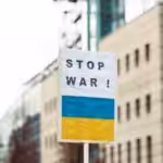 Image of a banner with a "Stop War" caption and the Ukrainian flag below. File photo.