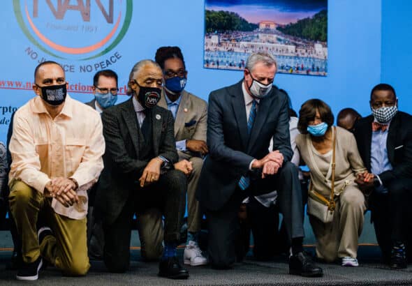 Hakeem Jeffries, left, kneeling with the Rev. Al Sharpton and Mayor Bill DeBlasio to commemorate the anniversary of George Floyd’s death. Photo: Gabriela Bhaskar for The New York Times.
