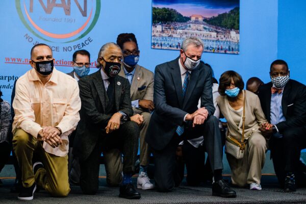 Hakeem Jeffries, left, kneeling with the Rev. Al Sharpton and Mayor Bill DeBlasio to commemorate the anniversary of George Floyd’s death. Photo: Gabriela Bhaskar for The New York Times.