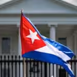 A demonstrator holds up the Cuban flag while protesting in front of the White House in Washington, D.C., on July 12, 2021. Photo: Jim Watson/AFP via Getty images.
