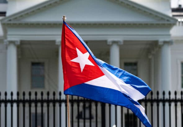 A demonstrator holds up the Cuban flag while protesting in front of the White House in Washington, D.C., on July 12, 2021. Photo: Jim Watson/AFP via Getty images.