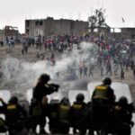 Riot police shoots tear gas at demonstrators at an airport in Arequipa. Photo: Diego Ramos/AFP/Getty Images.