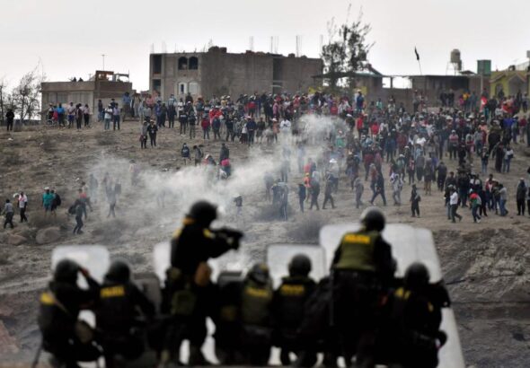 Riot police shoots tear gas at demonstrators at an airport in Arequipa. Photo: Diego Ramos/AFP/Getty Images.