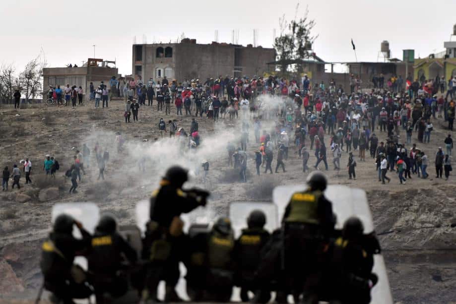 Riot police shoots tear gas at demonstrators at an airport in Arequipa. Photo: Diego Ramos/AFP/Getty Images.
