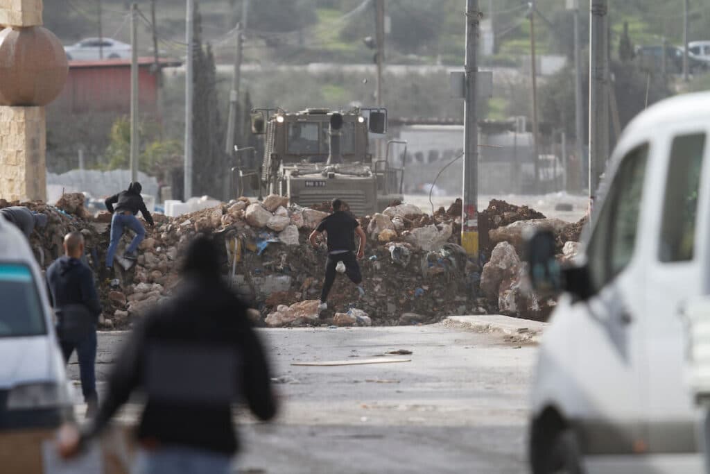 Palestinians clash with Israeli security forces during a protest against the siege of the village of Beita by the Israeli army, near the West Bank city of Nablus, on January 28, 2023. Photo: Mohammed Nasser/APA images.