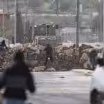 Palestinians clash with Israeli security forces during a protest against the siege of the village of Beita by the Israeli army, near the West Bank city of Nablus, on January 28, 2023. Photo: Mohammed Nasser/APA images.