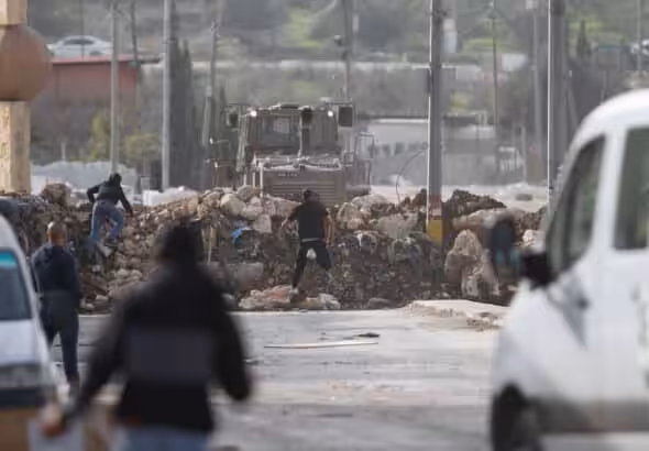 Palestinians clash with Israeli security forces during a protest against the siege of the village of Beita by the Israeli army, near the West Bank city of Nablus, on January 28, 2023. Photo: Mohammed Nasser/APA images.
