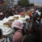 Relatives of 18 people killed by police repression wait with empty coffins outside the morgue of the Carlos Monge Medrano hospital in Juliaca, southern Peru, on January 10, 2023. Photo: Juan Carlos Cisneros/AFP.