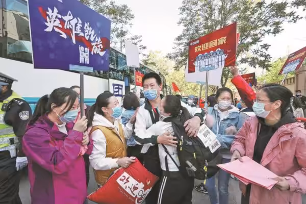 Members of the medical team from Beijing’s China-Japan Friendship Hospital meet their family members after enjoying a two-week holiday following a successful mission in Wuhan, Hubei province, on April 22, 2020. Photo: “Capturing COVID-19 in photos,” China Daily, December 26, 2022.