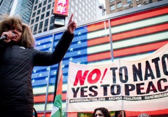 Claudia De La Cruz of The People's Forum speaks to a crowd outside of the US Army Recruiting Station in Times Square. Photo: Peoples Dispatch.