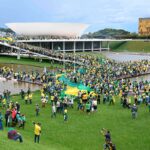Far-right Bolsonaro supporters, clad in green and yellow, storm symbolic buildings representing Brazilian democracy in Brasilia's Three Powers Plaza in an indisputable replication of the Trump-led Capitol Riots from January 6, 2021. Photo: Twitter/@kanekos69.
