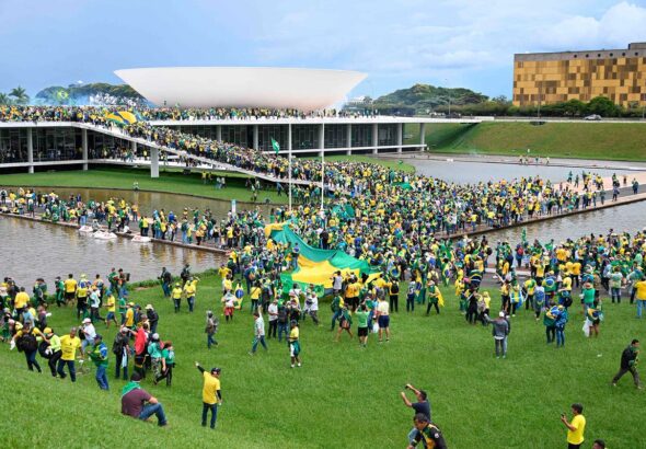 Far-right Bolsonaro supporters, clad in green and yellow, storm symbolic buildings representing Brazilian democracy in Brasilia's Three Powers Plaza in an indisputable replication of the Trump-led Capitol Riots from January 6, 2021. Photo: Twitter/@kanekos69.