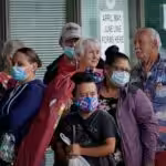 Masked adults line up outside a career center in Kentucky, US, hoping to find assistance with their unemployment claims. Photo: Reuters/Bryan Woolston.