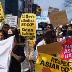 Demonstrators hold signs during an AANHPI Rally Against Hate in Flushing, Queens, New York. Photo: John Nacion/Star Max/IPX.