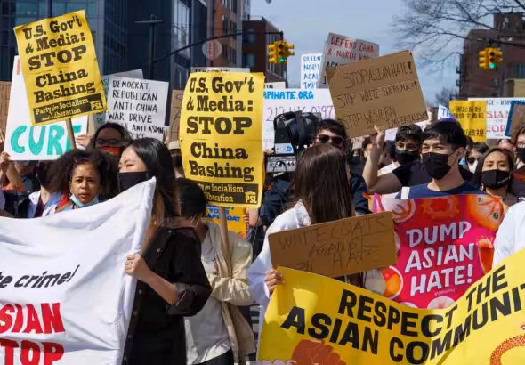 Demonstrators hold signs during an AANHPI Rally Against Hate in Flushing, Queens, New York. Photo: John Nacion/Star Max/IPX.