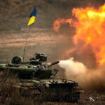 War tank with the Ukrainian flag firing in a field. File photo.