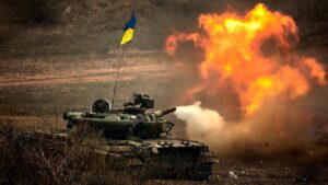 War tank with the Ukrainian flag firing in a field. File photo.