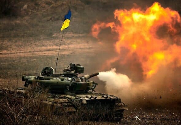 War tank with the Ukrainian flag firing in a field. File photo.