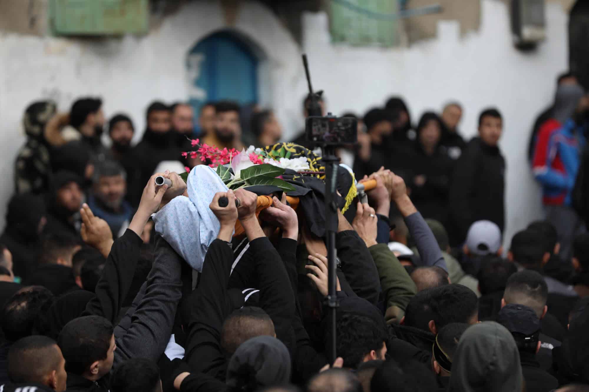 Mourners carry the bodies of two Palestinian resistance fighters who were killed in Jenin, January 14, 2023. Photo: APA Images.