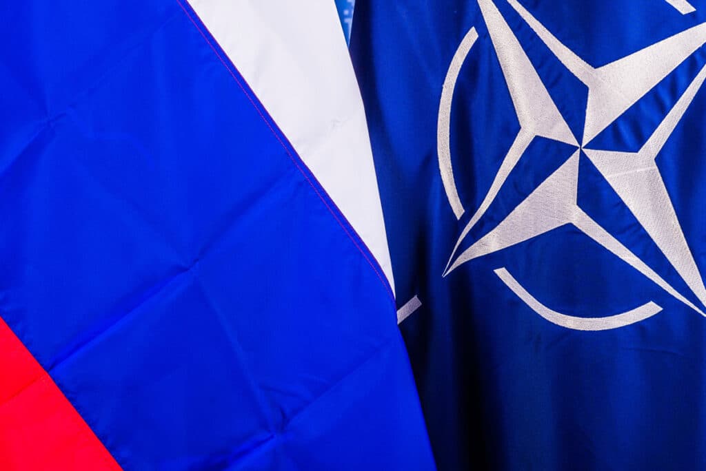 The Russian and NATO flags in contrast to each other. Photo: NATO