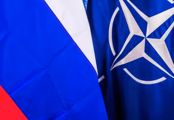 The Russian and NATO flags in contrast to each other. Photo: NATO