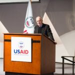 Speaker for the USAID at a conference. Photo: Liberation News.