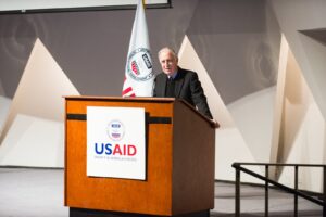Speaker for the USAID at a conference. Photo: Liberation News.