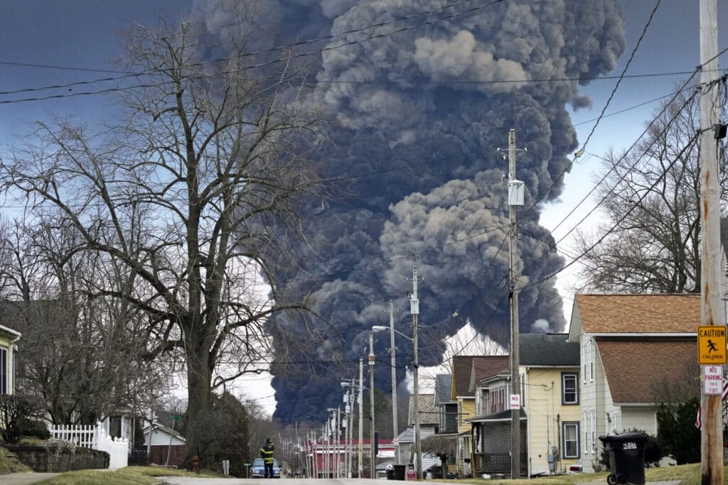 A black plume rises over East Palestine, Ohio, resulting from the derailment of a Norfolk Southern train carrying chemicals on Monday, February 6, 2023. Photo: Gene J. Puskar/AP.