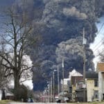 A black plume rises over East Palestine, Ohio, resulting from the derailment of a Norfolk Southern train carrying chemicals on Monday, February 6, 2023. Photo: Gene J. Puskar/AP.