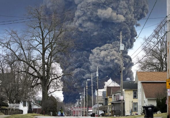 A black plume rises over East Palestine, Ohio, resulting from the derailment of a Norfolk Southern train carrying chemicals on Monday, February 6, 2023. Photo: Gene J. Puskar/AP.