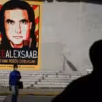 People walk past graffiti in favor of the release of Colombian businessman Alex Saab, amidst the Coronavirus pandemic, on the west side of the city in Caracas, Venezuela on September 8, 2021. Photo: Javier Campos/NurPhoto via Getty Images.