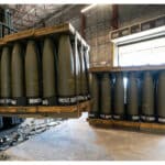 A U.S. Air Force staff sergeant checks pallets of 155 mm shells ultimately bound for Ukraine, at Dover Air Force Base, U.S., April 29, 2022. Photo: AFP.